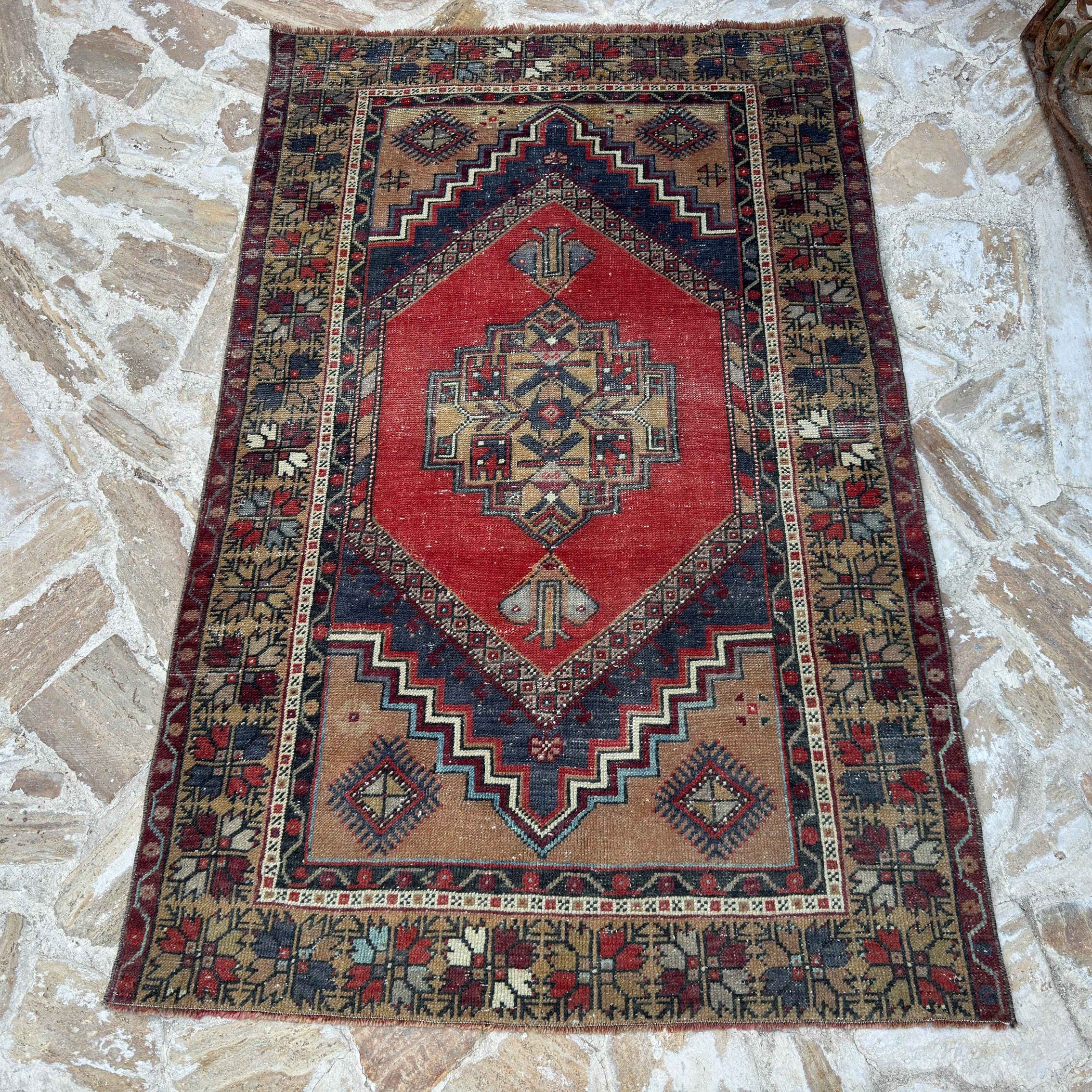 Red 4' x 6' vintage Turkish area rug in wool and cotton, shown on the floor.