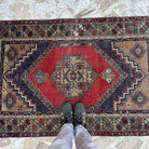 1970s red vintage Turkish area rug with traditional design, hand-knotted weave and low pile.