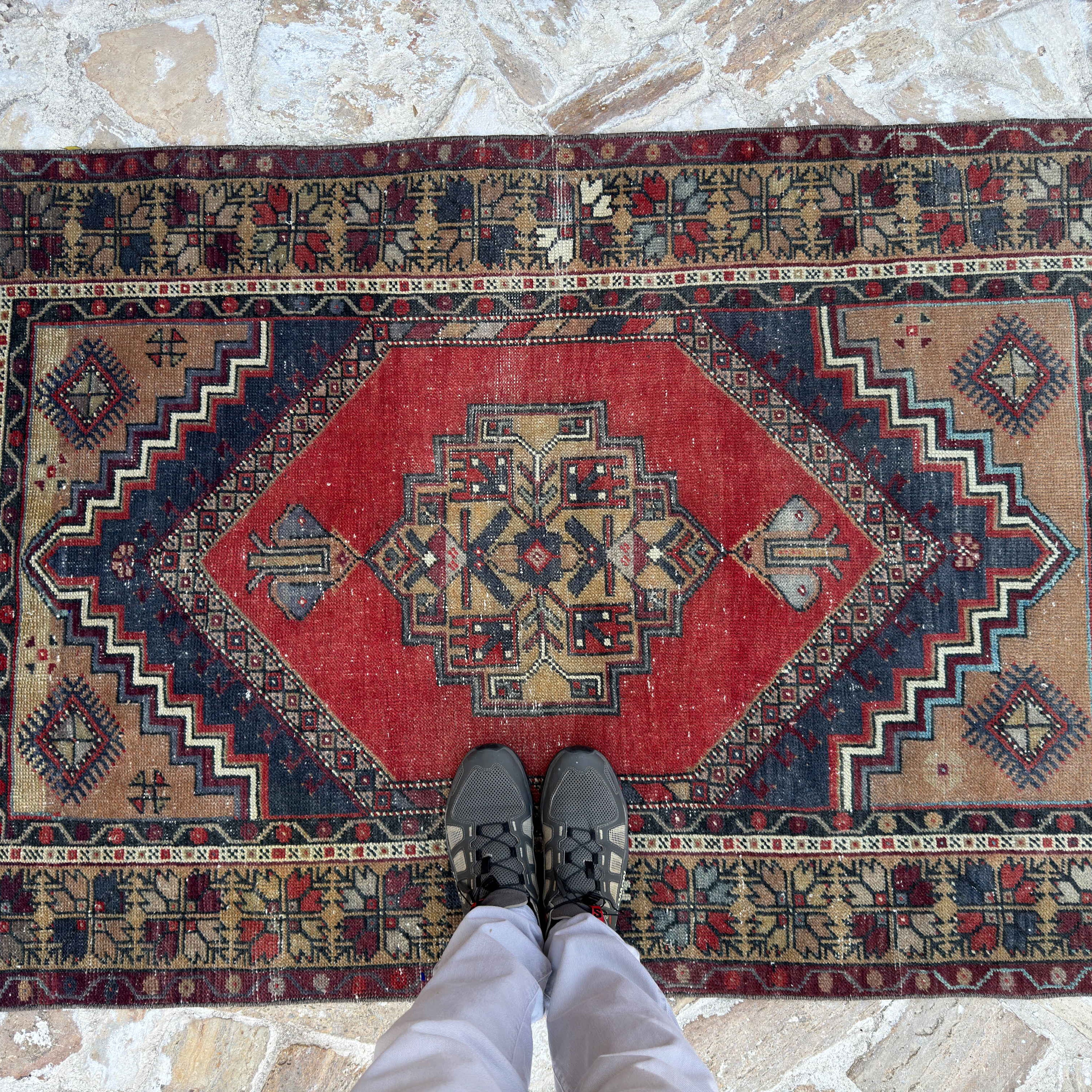 1970s red vintage Turkish area rug with traditional design, hand-knotted weave and low pile.