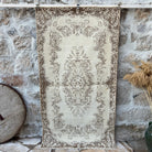 Beige 4' x 7' vintage area rug with medallion design, handmade in Turkey – India.