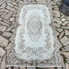 Beige 4' x 7' vintage Turkish area rug in wool and cotton, shown on the floor.