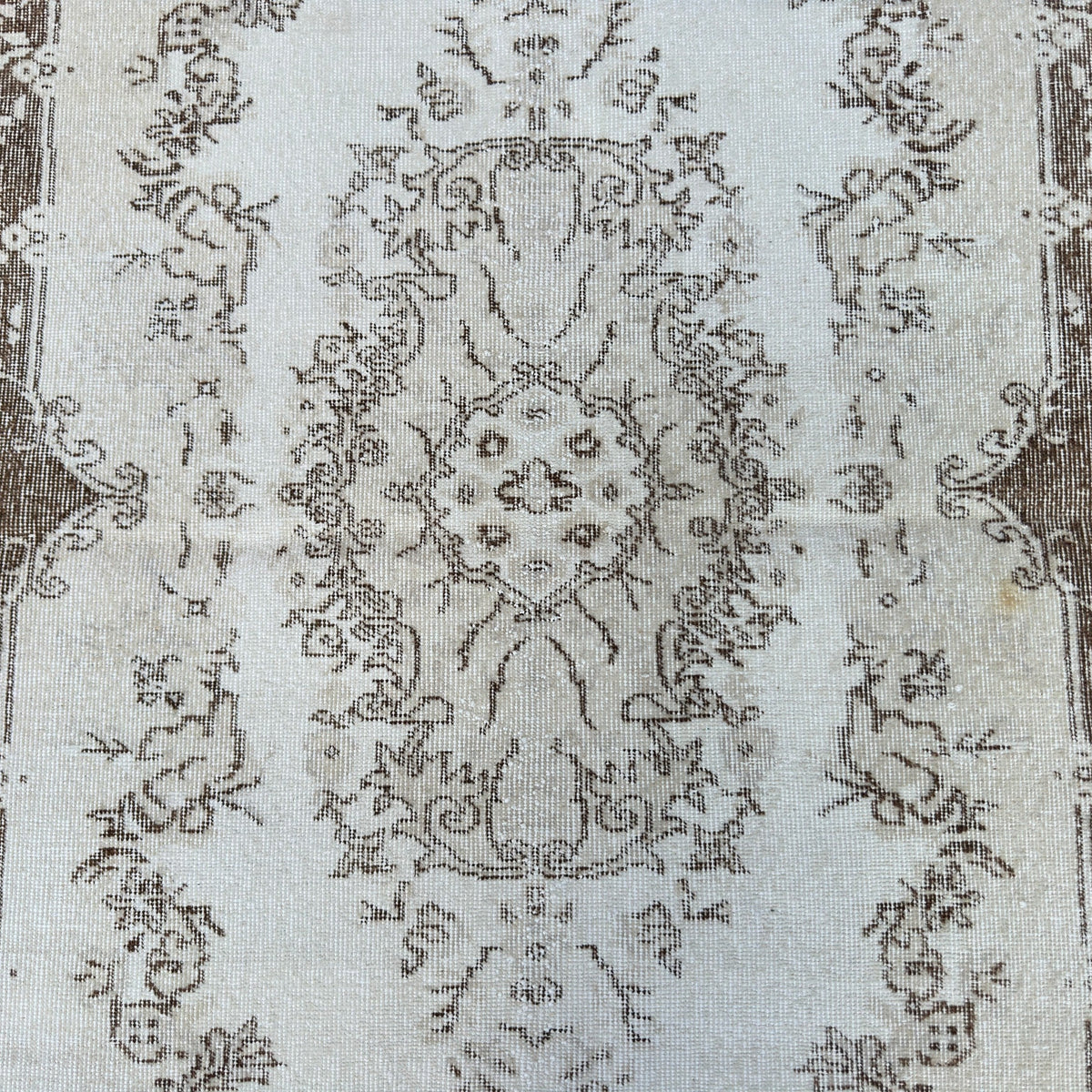 1970s beige vintage Turkish area rug with medallion design, hand-knotted weave and low pile.