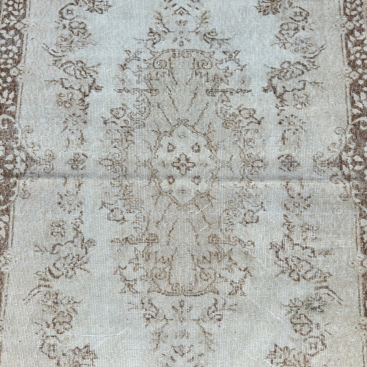1970s beige vintage Turkish area rug with medallion design, hand-knotted weave and low pile.