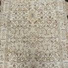 1970s beige vintage Turkish area rug with floral design, hand-knotted weave and low pile.