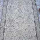 Close-up of the beige vintage Turkish area rug showing traditional details, hand-knotted weave, wool and cotton and low pile.