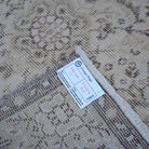 Beige 4' x 7' vintage Turkish area rug from the 1970s with traditional design.