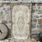 Brown 4' x 7' vintage area rug with medallion design, handmade in Turkey – Collier.