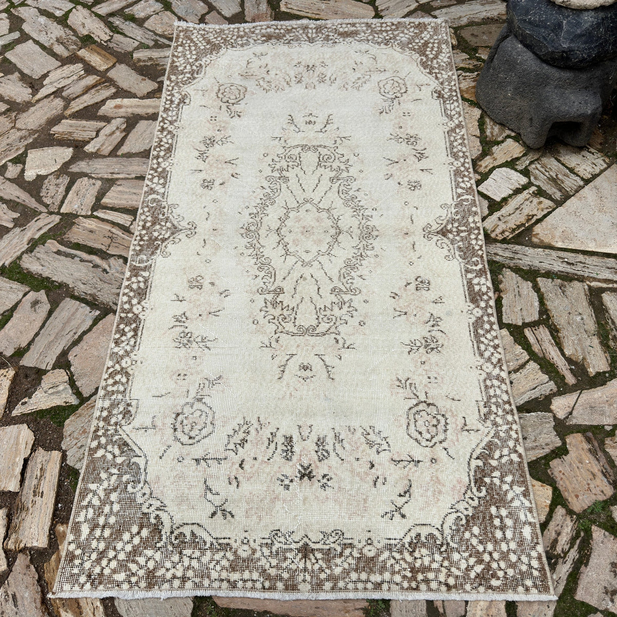Brown 4' x 7' vintage Turkish area rug in wool and cotton, shown on the floor.