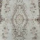1970s brown vintage Turkish area rug with medallion design, hand-knotted weave and low pile.