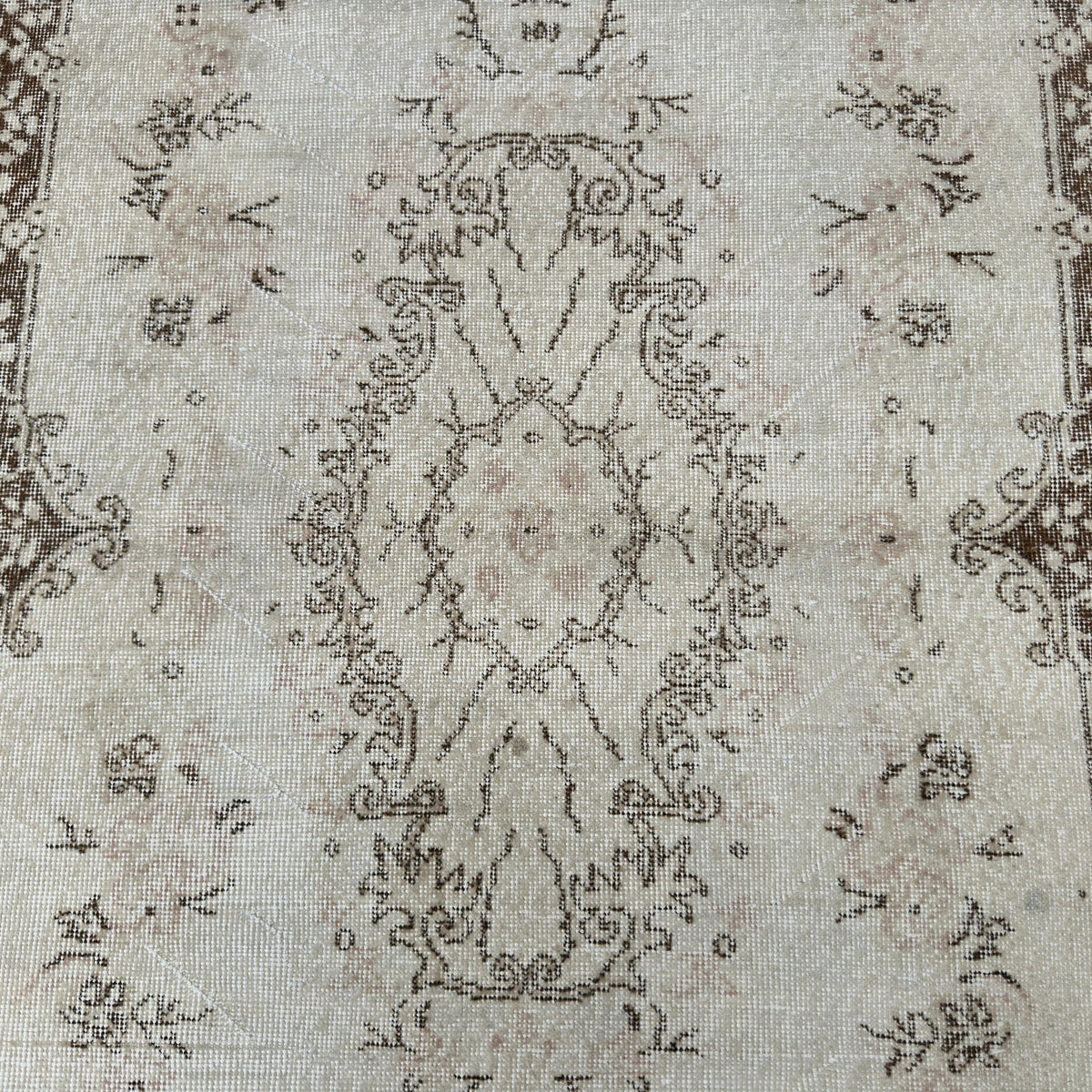 1970s brown vintage Turkish area rug with medallion design, hand-knotted weave and low pile.