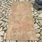 Brown 4' x 7' vintage Turkish area rug in wool and cotton, shown on the floor.