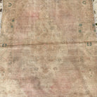 1970s brown vintage Turkish area rug with neutral design, hand-knotted weave and low pile.