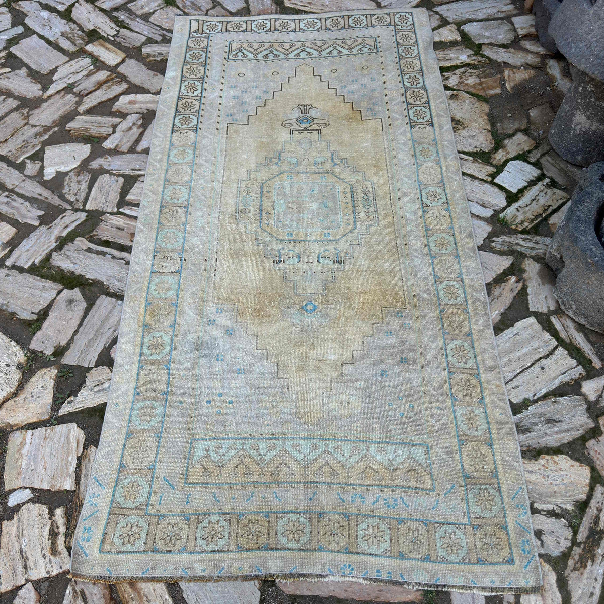 Pale Yellow 4' x 7' vintage Turkish area rug in wool and cotton, shown on the floor.