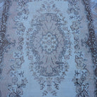 Close-up of the pink vintage Turkish area rug showing traditional details, hand-knotted weave, wool and cotton and low pile.