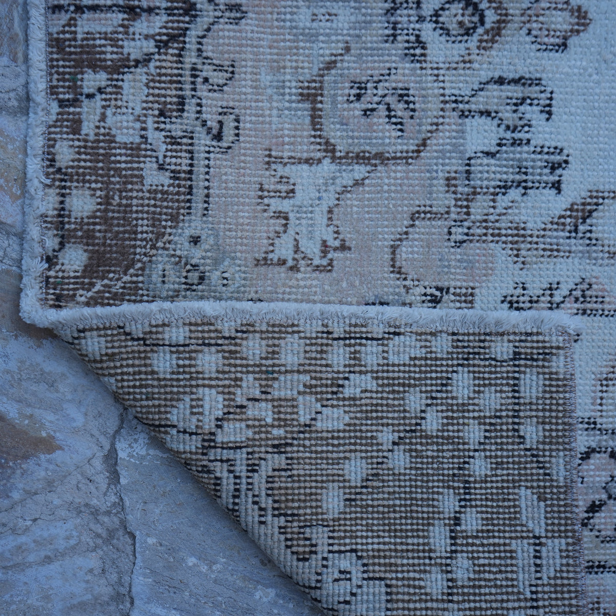 1970s pink vintage Turkish area rug with traditional design, hand-knotted weave and low pile.
