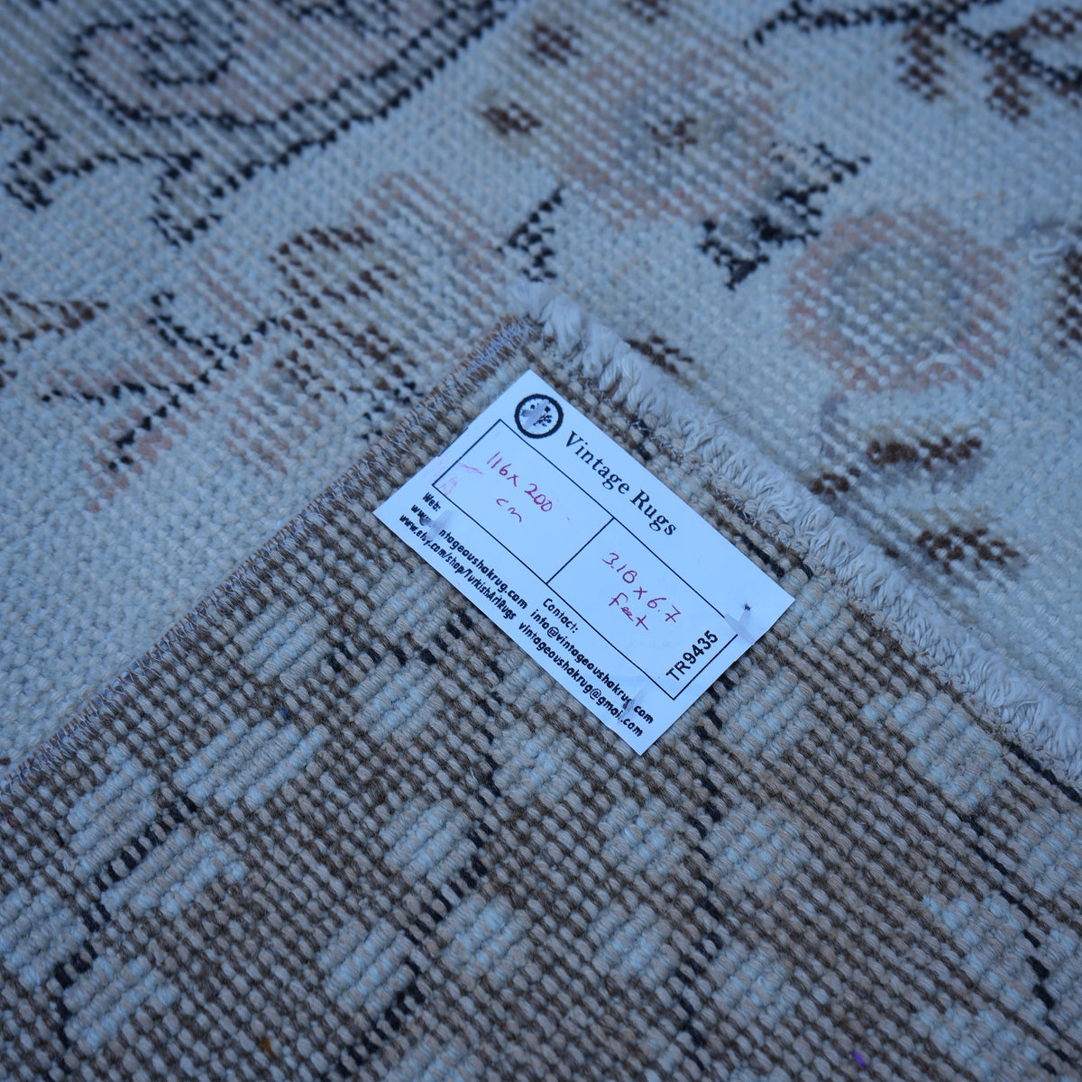 Pink 4' x 7' vintage Turkish area rug from the 1970s with traditional design.