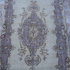 Close-up of the purple vintage Turkish area rug showing traditional details, hand-knotted weave, wool and cotton and low pile.