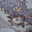 Purple 4' x 7' vintage Turkish area rug in wool and cotton, shown on the floor.