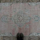 1970s pale red vintage Turkish area rug with traditional design, hand-knotted weave and low pile.