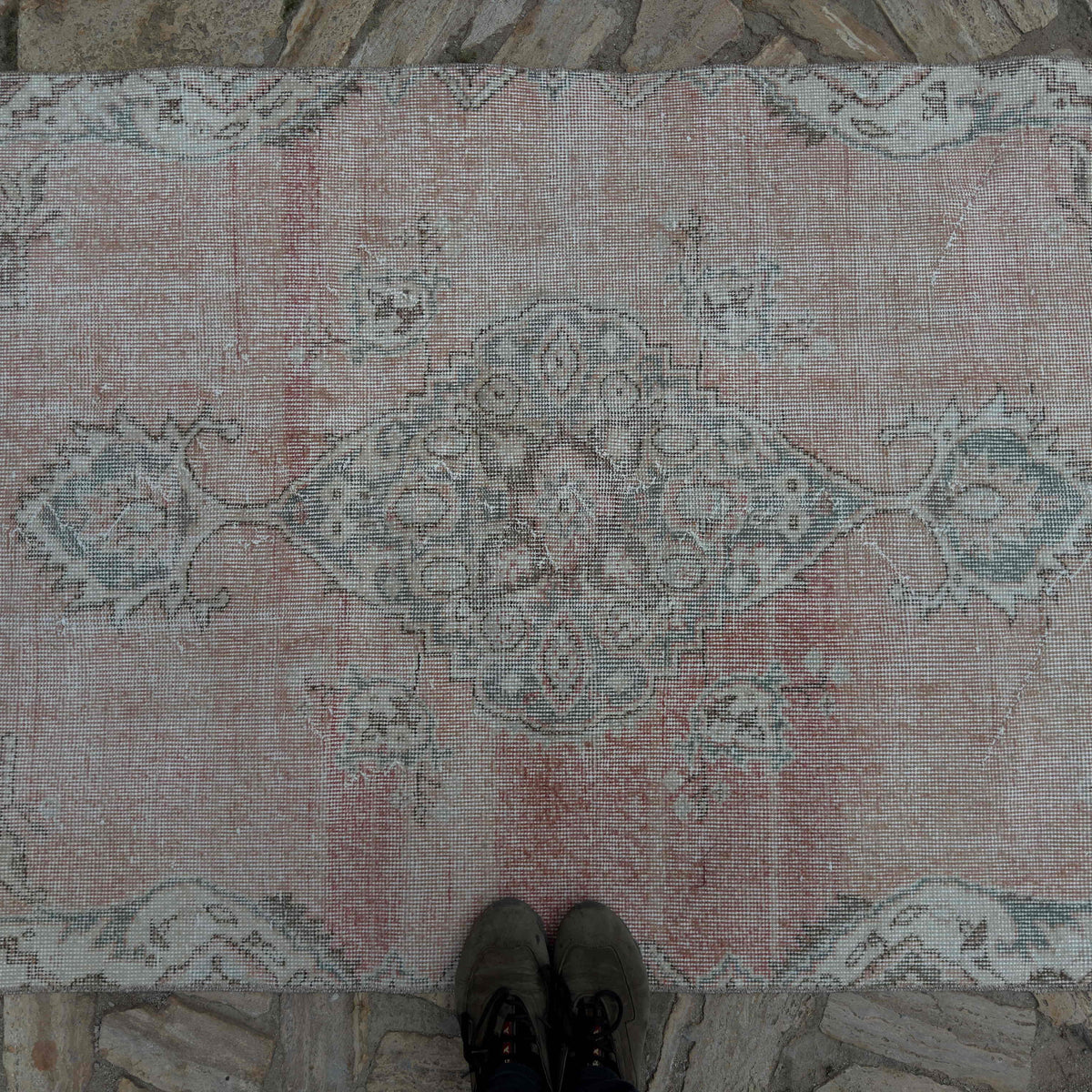 1970s pale red vintage Turkish area rug with traditional design, hand-knotted weave and low pile.