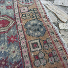 Close-up of the red vintage Turkish area rug showing traditional details, hand-knotted weave, wool and cotton and low pile.