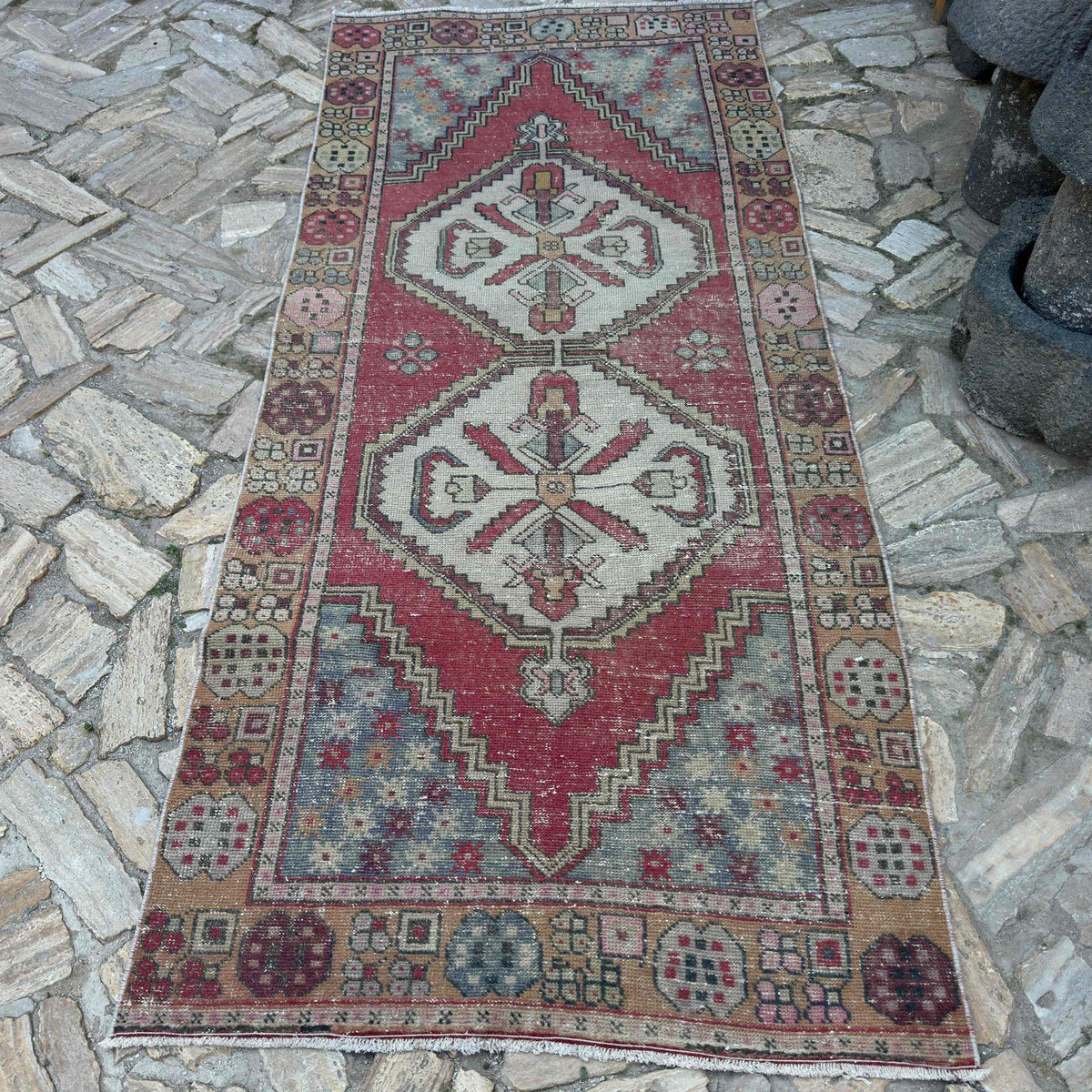 Red 4' x 9' vintage Turkish area rug in wool and cotton, shown on the floor.