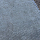 Close-up of the beige vintage Turkish area rug showing neutral details, hand-knotted weave, wool and cotton and low pile.