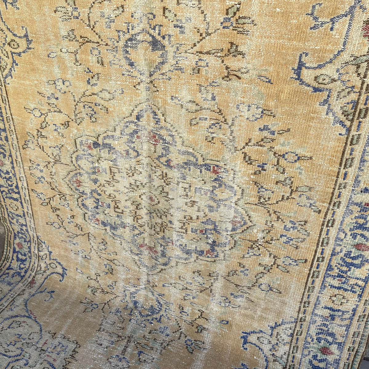 Blue 6' x 9' vintage Turkish area rug in wool and cotton, shown on the floor.