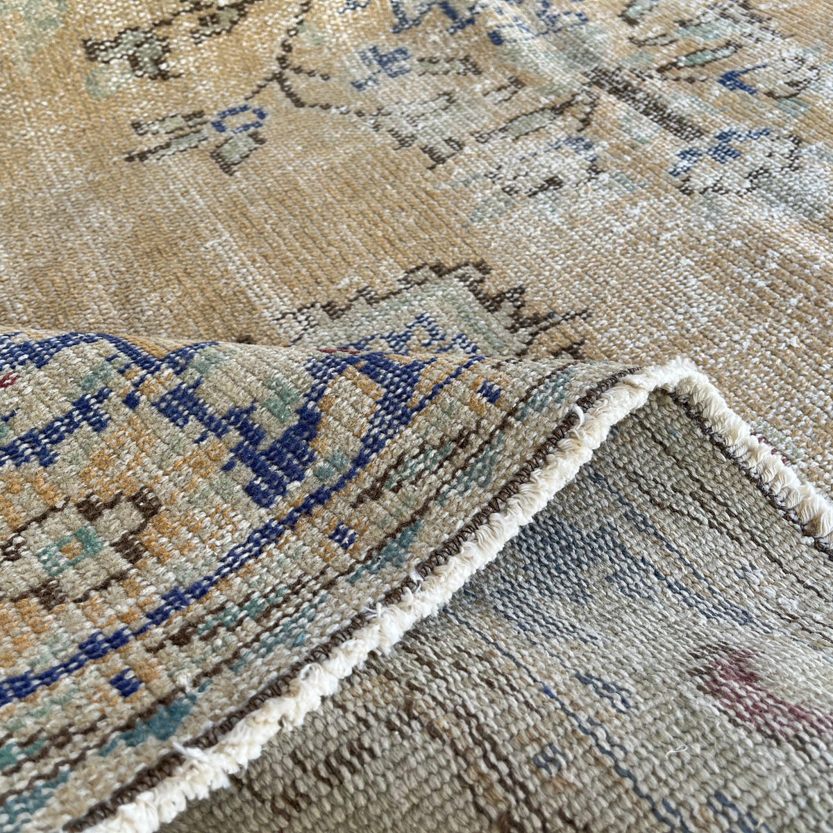 1970s blue vintage Turkish area rug with medallion design, hand-knotted weave and low pile.