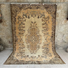 Brown 6' x 9' vintage area rug with medallion design, handmade in Turkey – Cady.