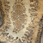 Brown 6' x 9' vintage Turkish area rug in wool and cotton, shown on the floor.