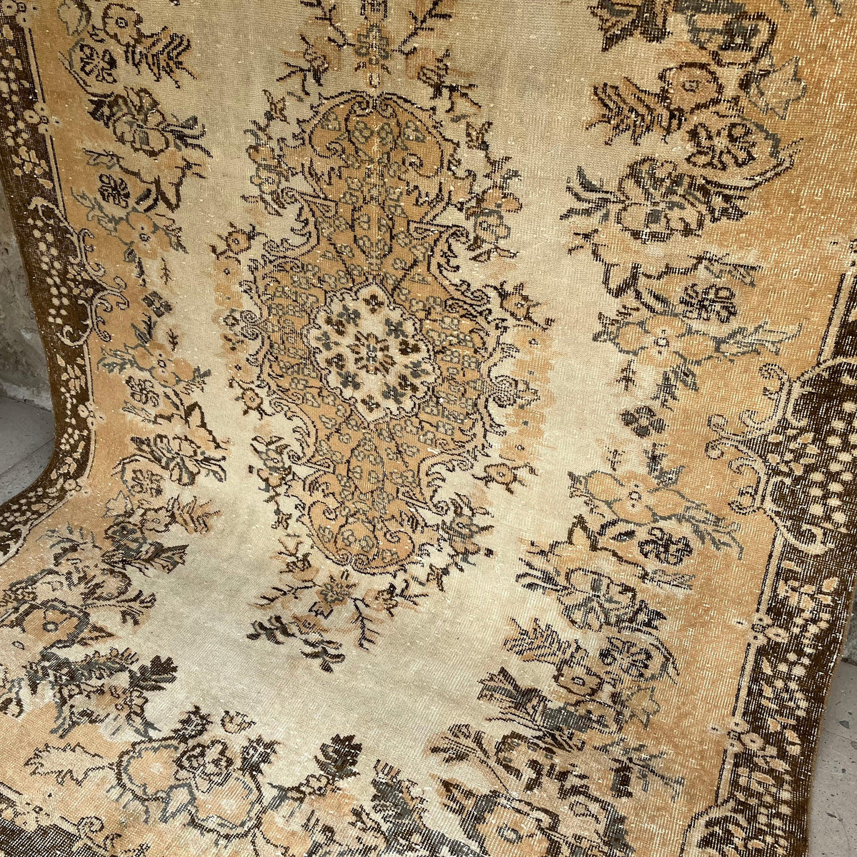 Brown 6' x 9' vintage Turkish area rug in wool and cotton, shown on the floor.