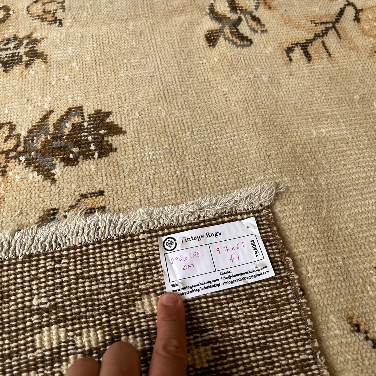 1970s brown vintage Turkish area rug with medallion design, hand-knotted weave and low pile.