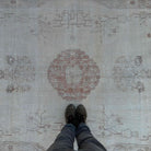 1970s pale red vintage Turkish area rug with medallion design, hand-knotted weave and low pile.