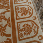 Close-up of the pale orange vintage Turkish art deco rug showing traditional and medallion details, hand-knotted weave, wool and cotton and low pile.