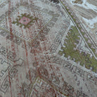 Close-up of the beige vintage Turkish bohemian rug showing traditional and neutral details, hand-knotted weave, wool and cotton and low pile.