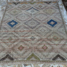 Beige 6' x 7' vintage Turkish bohemian rug in wool and cotton, shown on the floor.