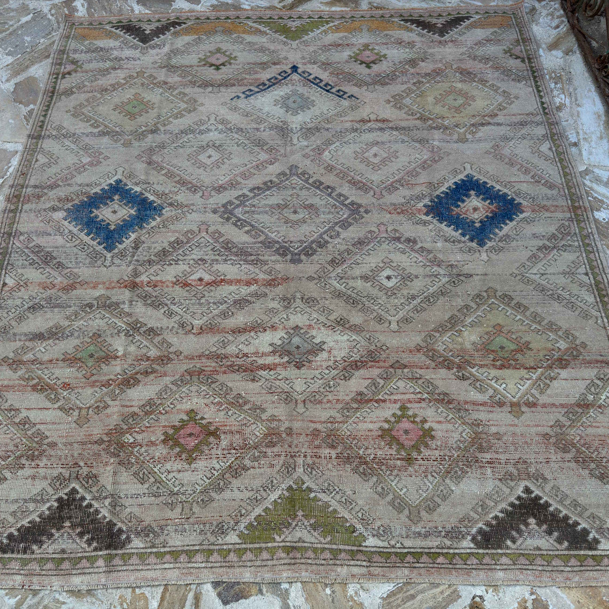 Beige 6' x 7' vintage Turkish bohemian rug in wool and cotton, shown on the floor.
