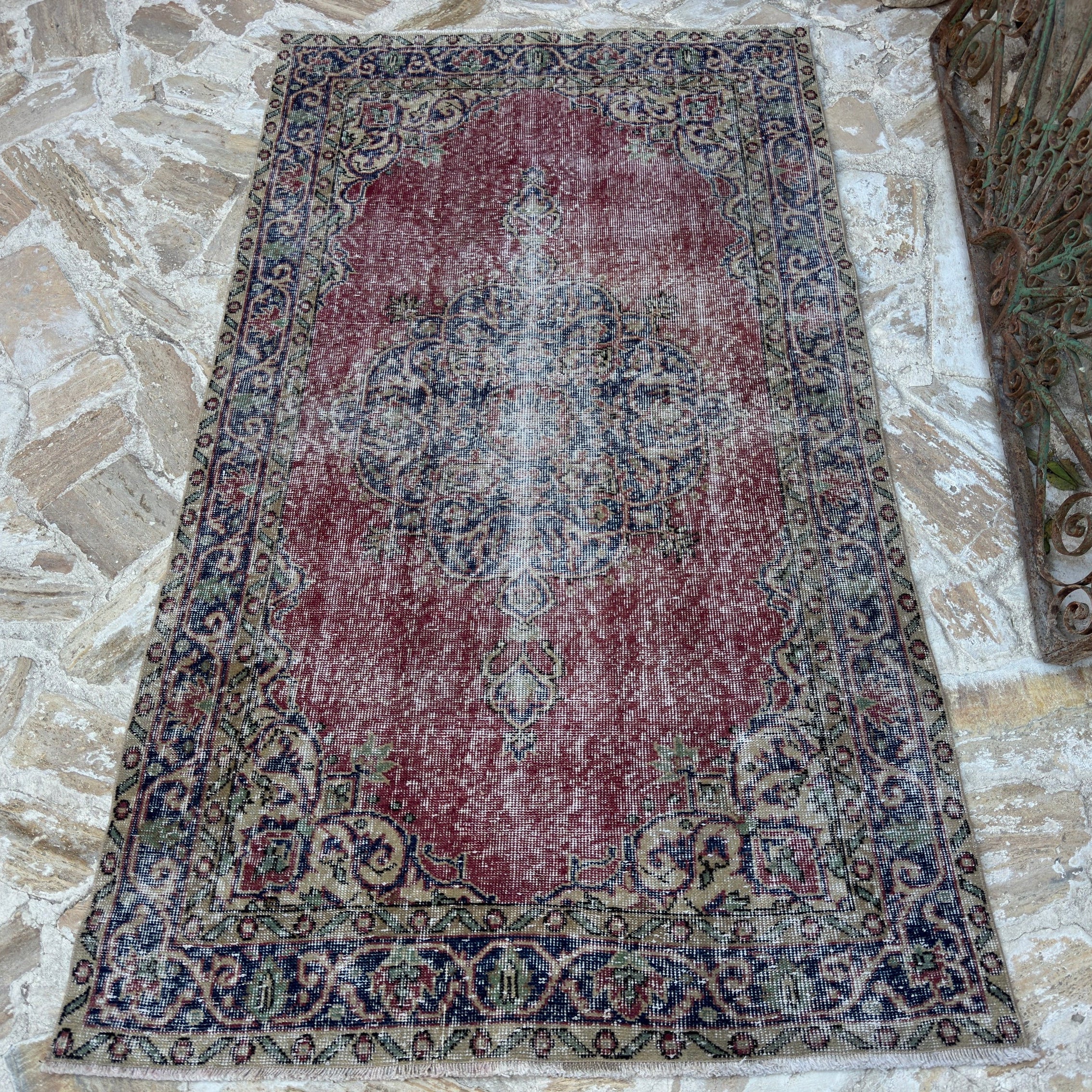 Red 4' x 7' vintage Turkish decorative rug in wool and cotton, shown on the floor.