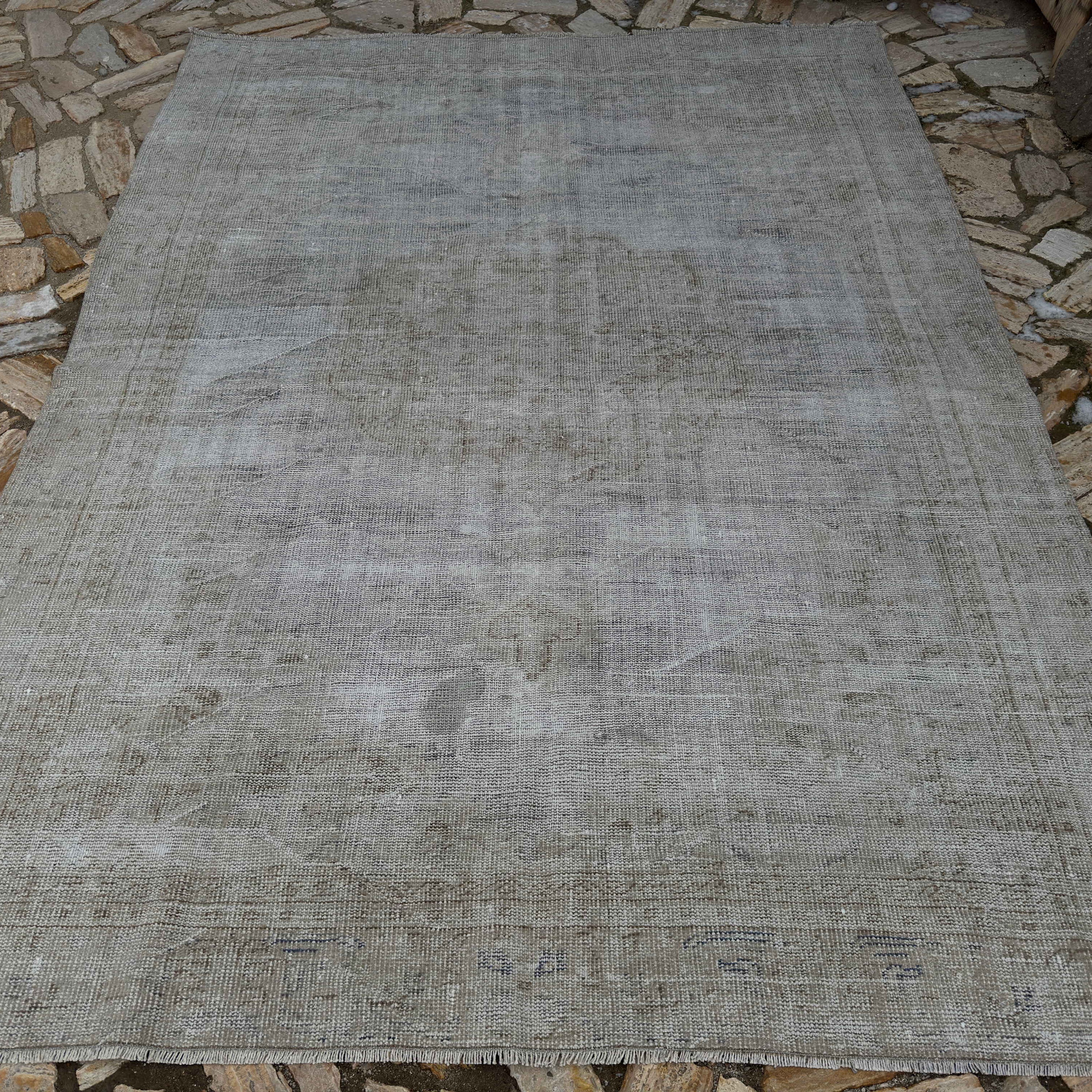 Pale Gray 7' x 9' vintage Turkish distressed carpet in wool and cotton, shown on the floor.
