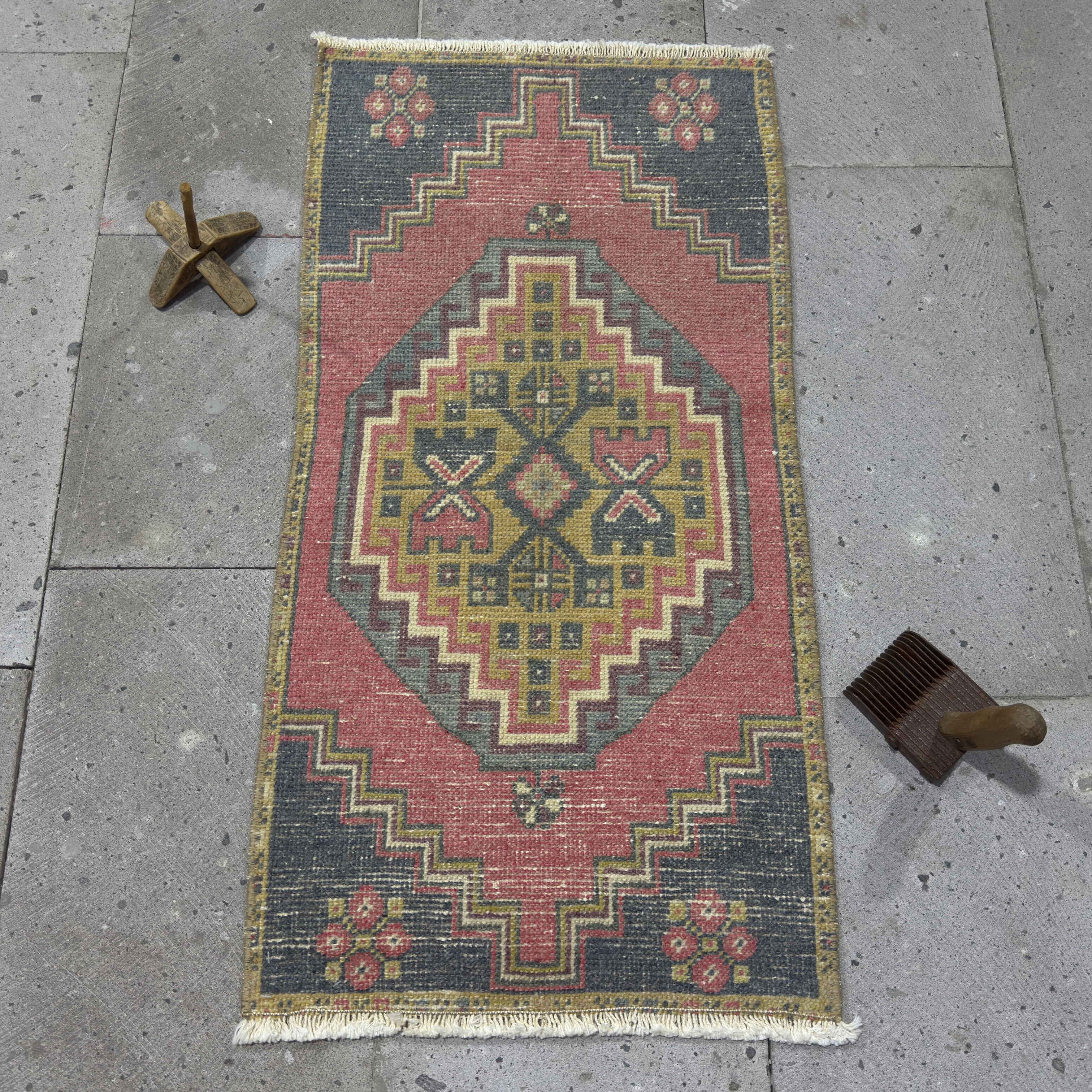 Red 1' x 3' vintage Turkish distressed rug in wool and cotton, shown on the floor.