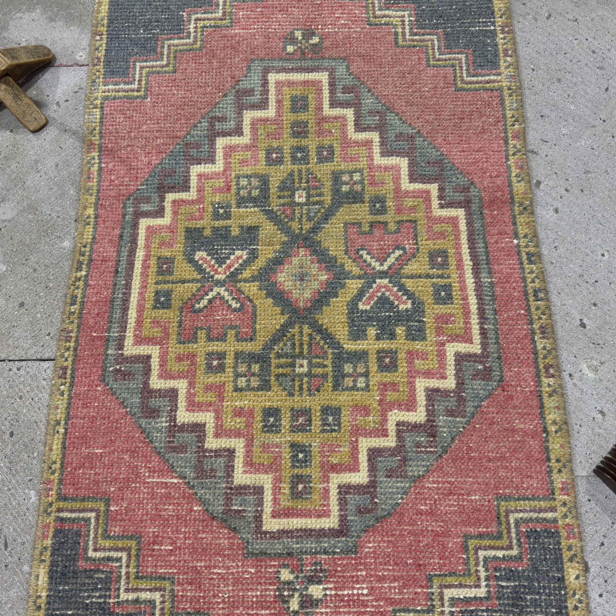 1970s red vintage Turkish distressed rug with traditional design, hand-knotted weave and low pile.