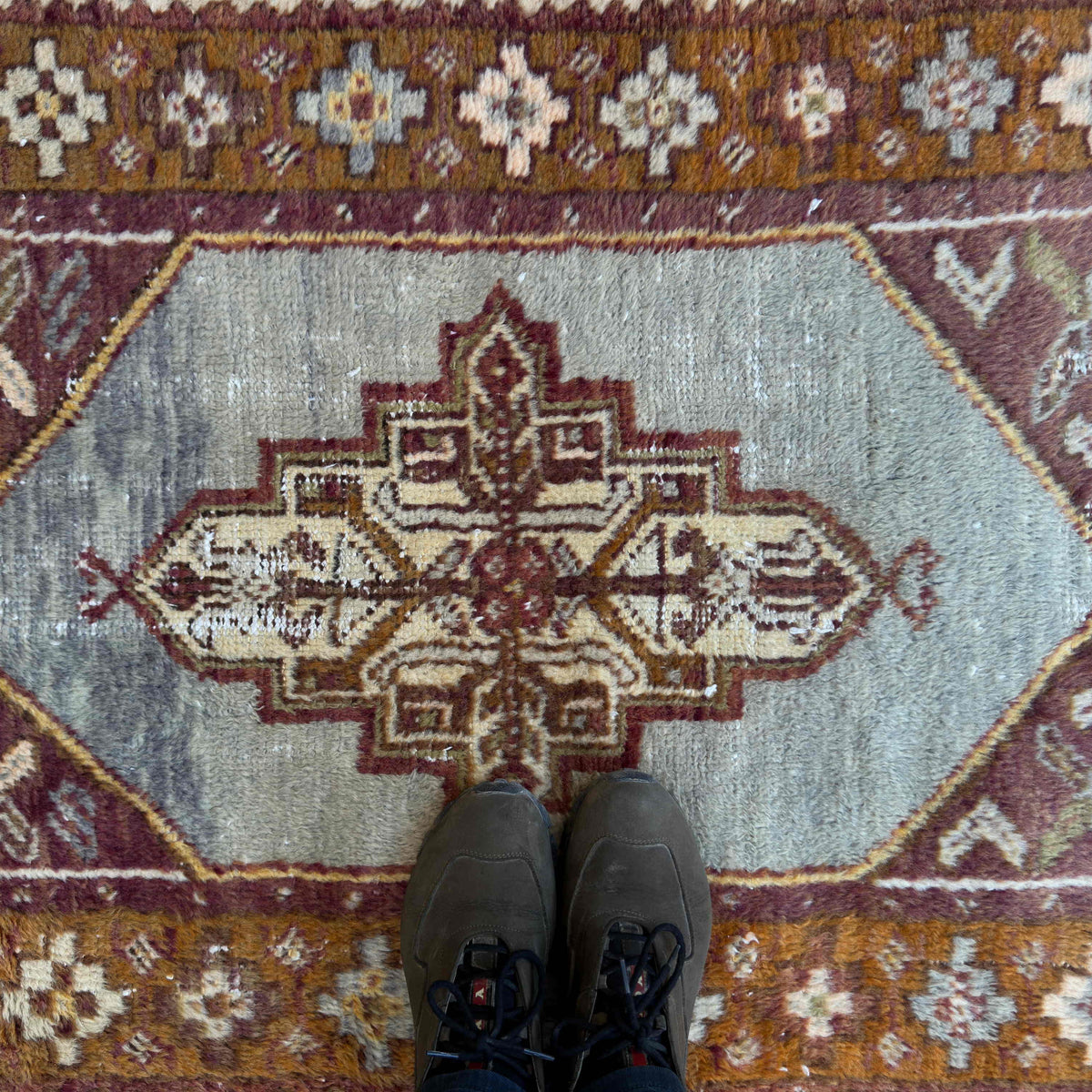 1970s orange vintage Turkish distressed rug with traditional design, hand-knotted weave and low pile.