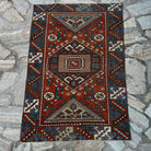 Red 3' x 4' vintage Turkish distressed rug in wool and cotton, shown on the floor.