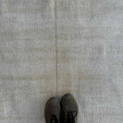 1970s beige vintage Turkish distressed rug with neutral design, hand-knotted weave and low pile.
