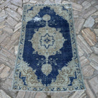 Blue 3' x 5' vintage Turkish distressed rug in wool and cotton, shown on the floor.