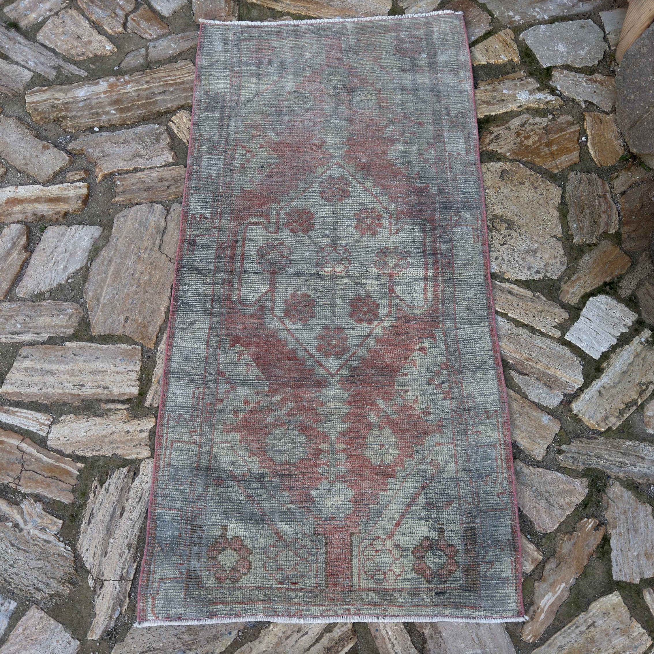 Red 3' x 5' vintage Turkish distressed rug in wool and cotton, shown on the floor.