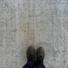 1970s beige vintage Turkish distressed rug with neutral design, hand-knotted weave and low pile.
