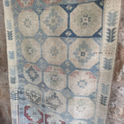 Blue 3' x 7' vintage Turkish distressed rug in wool and cotton, shown on the floor.