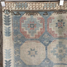 1970s blue vintage Turkish distressed rug with traditional design, hand-knotted weave and low pile.